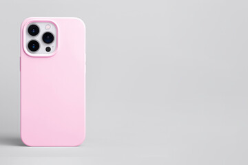 pink phone case mockup, iPhone 14 pro mock up back view isolated on grey background, banner with...