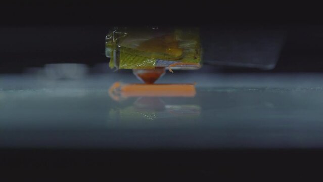 3d printer printing orange part