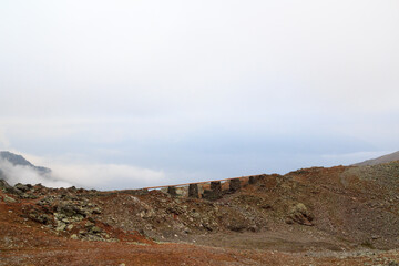 Aqueduct Tarscher Jochwaal in the mountains and fog in South Tyrol, Italy