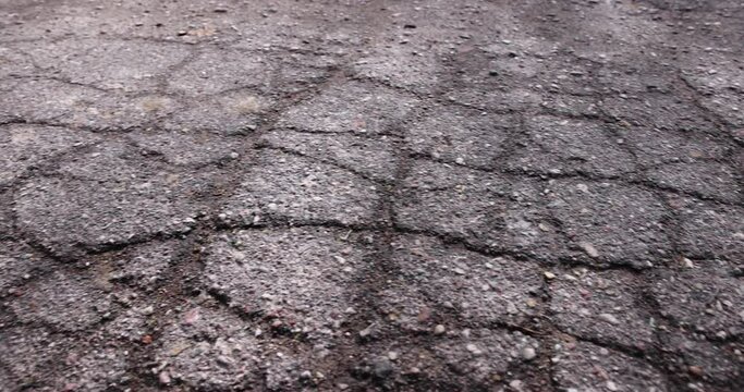 damaged asphalt on a highway, a close-up of an old road with cracks and damage