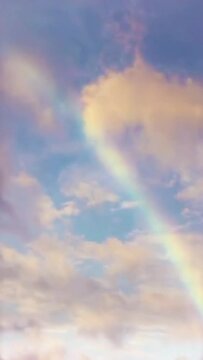Vertical video Rainbow in cloudy sky timelapse loop, seamless looping animated background motion backdrop sky and clouds, beautiful weather