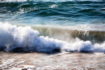 Wave crashing on to beach
