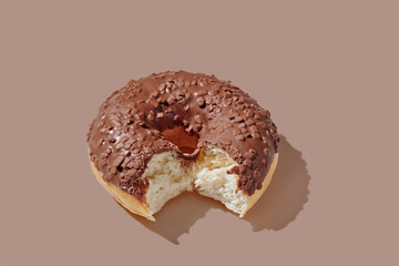 Chocolate donut on brown background