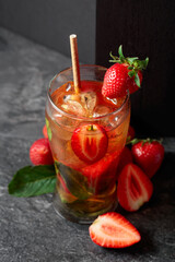 Summer refreshing drink with ice, mint, and strawberries.