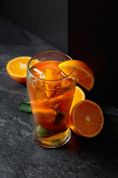 Summer refreshing drink with ice, mint, and orange.