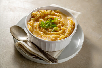 Root mash. Root vegetables mashed in a bowl. Garnished with oil and herbs.