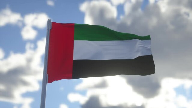 Flag of United Arab Emirates UAE waving at wind against beautiful blue sky