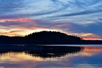 sunset over the lake. Nature landscape. Nature of Europe. reflection, blue sky and yellow sunlight. landscape during sunset. Visible forest at sunset