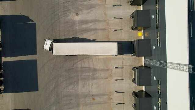 areal footage of truck parking into dock