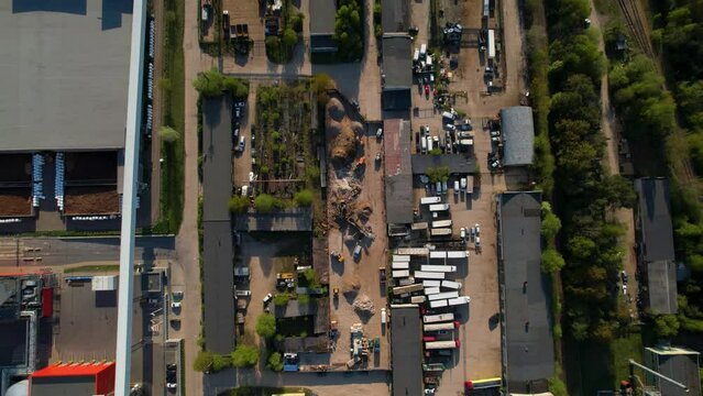 Areal footage of exterior of logistics center with trucks loaded 