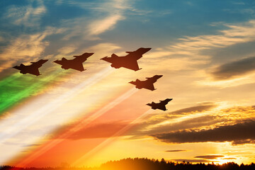 Aircraft silhouettes with flag color trails on background of sunset. Italian Air Force Day. - obrazy, fototapety, plakaty