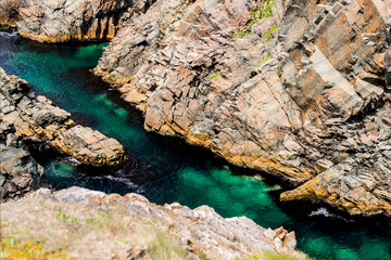 Green water sea passage with cliffs