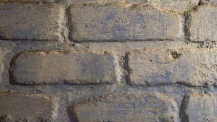 Brick background. The brick is covered with blue paint. Old brickwork