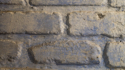 Brick background. The brick is covered with blue paint. Old brickwork