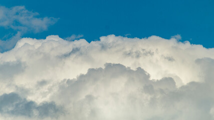 Blue sky with white clouds. Fluffy white clouds and blue sky. White fluffy clouds close-up