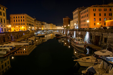 LIVORNO ITALY IN ONE OF ITS CANALS WHERE THE CITY IS REFLECTED