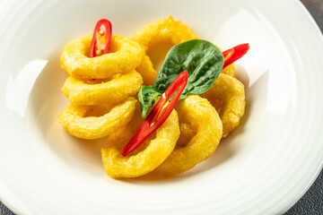 fried squids or octopus calamari with sauce. Food recipe background. Close up