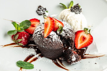 Chocolate fondant lava cake with strawberries. Restaurant menu, dieting, cookbook recipe top view