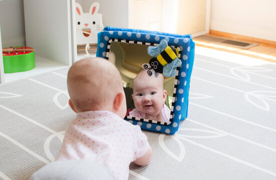 Baby looking in the mirror during tummy time