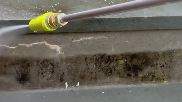 Close up from cleaning stones stairs with power washer