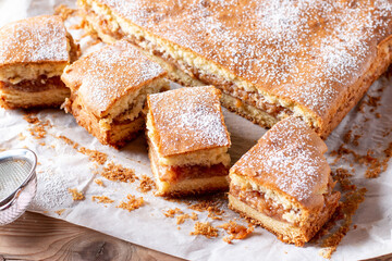 Apple pie slices (traditional Hungarian version) on rustic wooden background