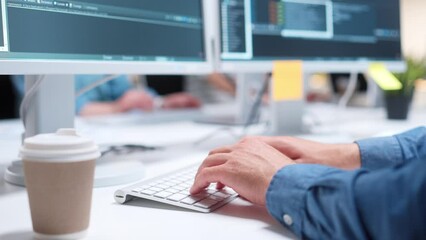 Close-up view of IT programmer typing code or creating software on white keyboard. Cup with coffee standing on table. Man using computers and working at office. Technology concept. - Powered by Adobe
