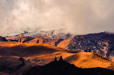 Naklejka premium Gergethi Trinity Church during sunset in Kazbegi, country of Georgia