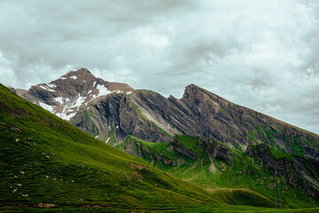 Mountain view Mannlichen. Snowy mountain ridges and deep valleys with green fields, Bernese Oberland, Switzerland Alps