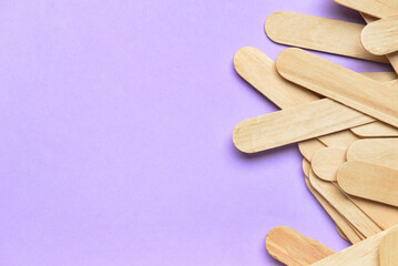 Ice cream sticks on purple background, closeup