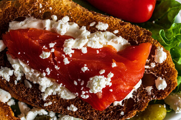 Smoked salmon and goat cheese crostini served on a bed of salad greens