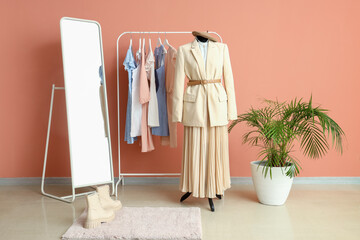 Interior of fashion designer's studio with mannequin, rack and clothes