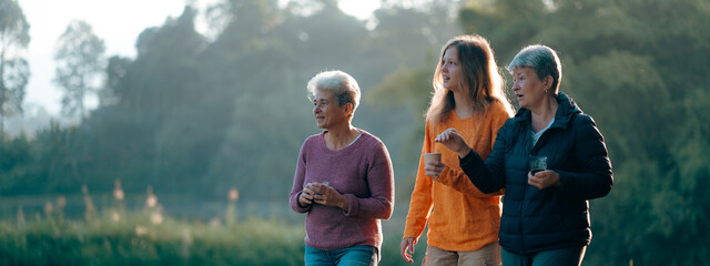 family of senior woman and teenager talking about activity recreation and picnic while coffee breakfast together in morning weekend, camping travel vacations trip in holiday, outdoor leisure party