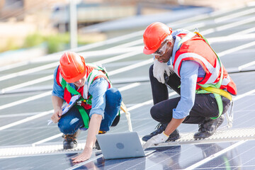 Technician engineer service meeting and checking solar cell on rooftop of industrial factory. Inspection worker repair solar cell panels. Clean Renewable energy, Ecology and alternative power concept