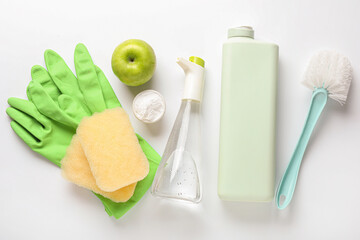 Composition with bottle of vinegar, detergent, baking soda and cleaning supplies on white background