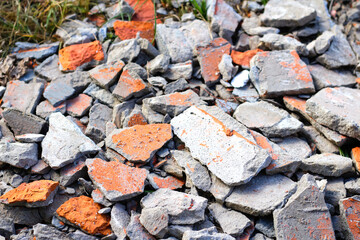 Shattered, broken bricks on nature background. rubble ruin brick building wall broken demolition destruction pile isolated on white background. War ruins. Out of focus