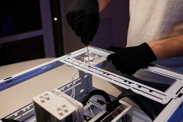 A computer technician assembles a desktop computer with new parts. Upgrading or replacing PC parts. - obrazy, fototapety, plakaty