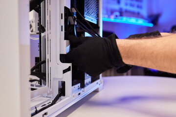 A computer technician assembles a desktop computer with new parts. Upgrading or replacing PC parts.