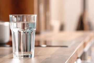 Glass of water on kitchen counter, closeup