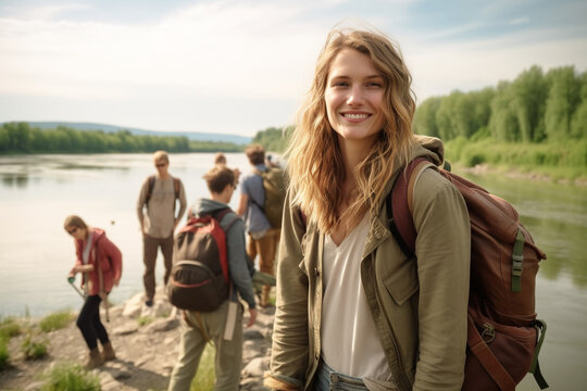 young adult woman traveling, hiking along a small river in nature with other tourists or friends, fictional place