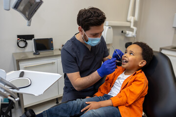 Male doctor in mask checking up his patient