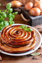 Baked homemade sausage close up on wooden table