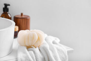 Fototapeta na wymiar Different cosmetic products, towel and sponge in bathroom