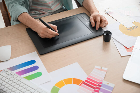 Male designer using graphic tablet in office