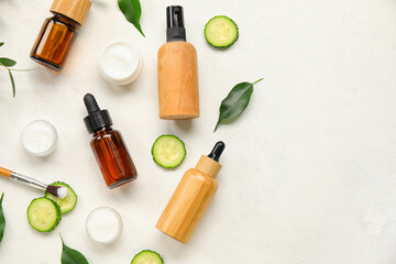 Composition with natural cosmetic products and cucumber on light background