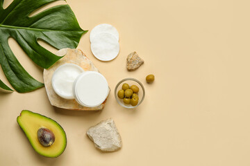 Composition with jar of natural cream, ingredients and palm leaf on color background