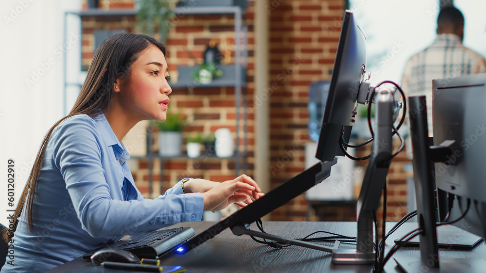 Poster asian female engineer using touchscreen display to create game interface on professional software. c