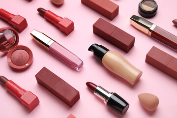 Obraz premium Decorative cosmetics with lipsticks on pink background, closeup