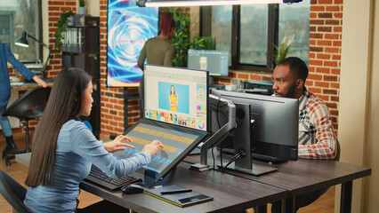 Professional picture retoucher using editing software with graphic tablet, working on multimedia...