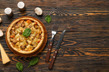 Mushroom pie with spinach leaves and champignons on wooden table