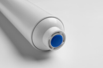 New water filter cartridge on grey background, closeup